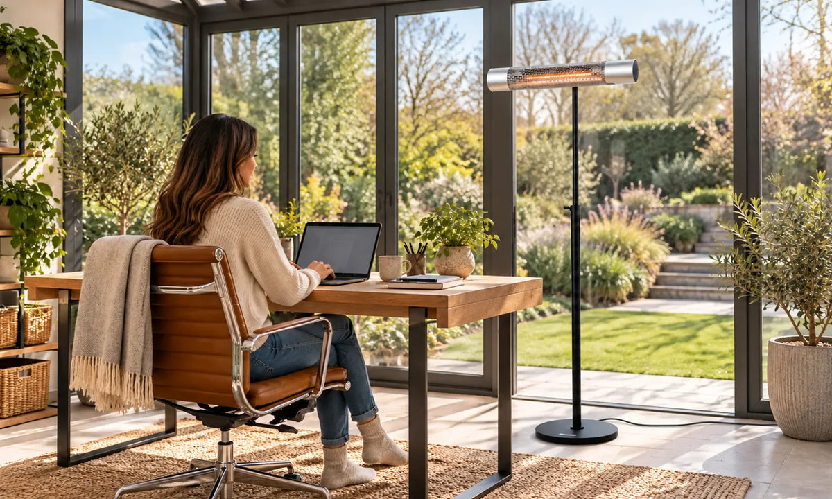 Zilveren Herschel CALIFORNIA 2000 W infrarood terrasverwarmer bij een thuiskantoor in een tuinkamer