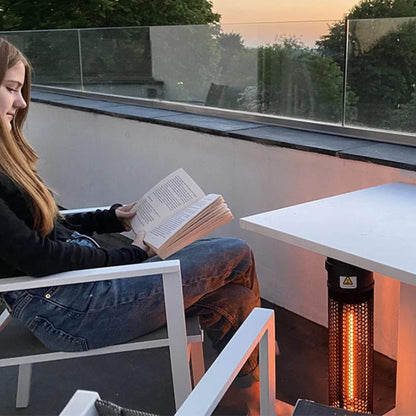 Herschel HAVANA 800 W, zwarte  terrasverwarmer naast een zitplaats op het terras